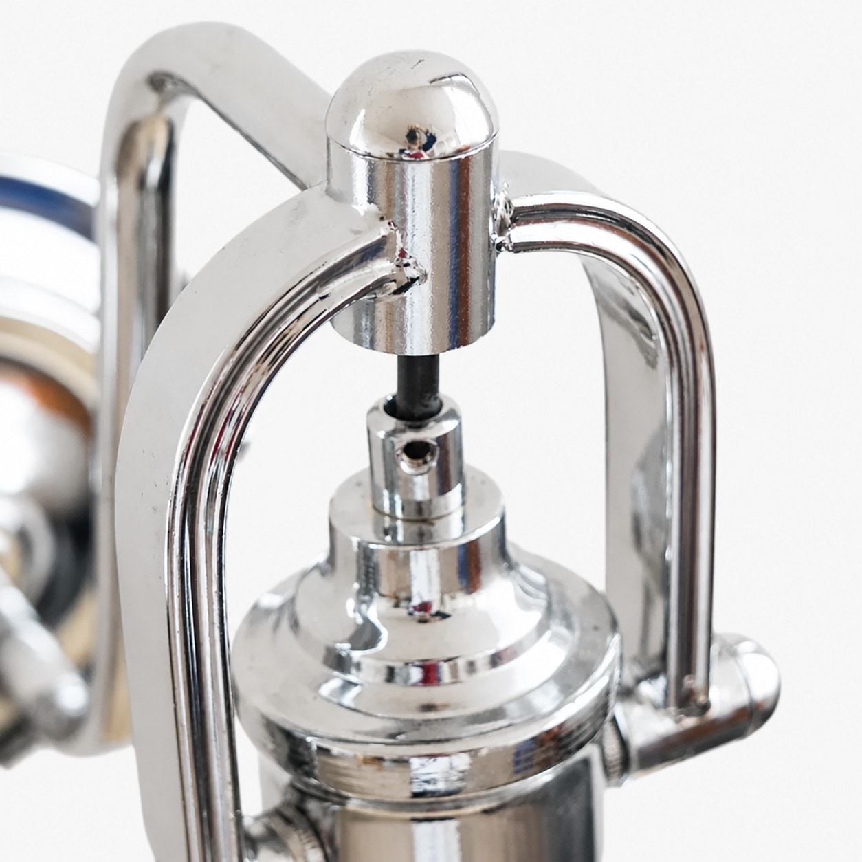 Chrome holder detail on Bauhaus glass wall sconce